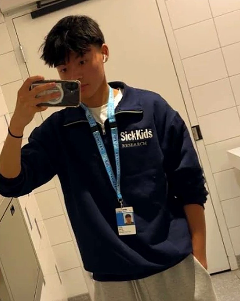 Andy Wang, founder of CodeReach, wearing a SickKids Research sweater